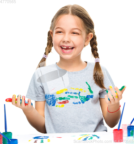 Image of Portrait of a cute girl playing with paints