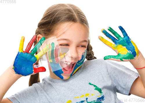 Image of Portrait of a cute girl playing with paints