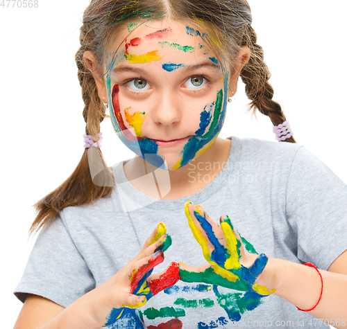 Image of Portrait of a cute girl playing with paints