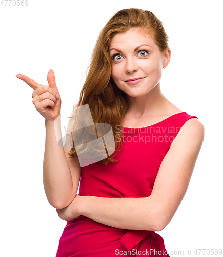 Image of Portrait of a young woman pointing to the left