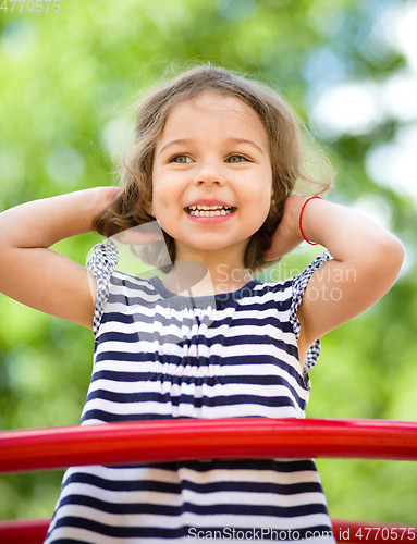 Image of Cute little girl is playing in playground