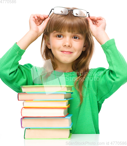 Image of Little girl is reading a book