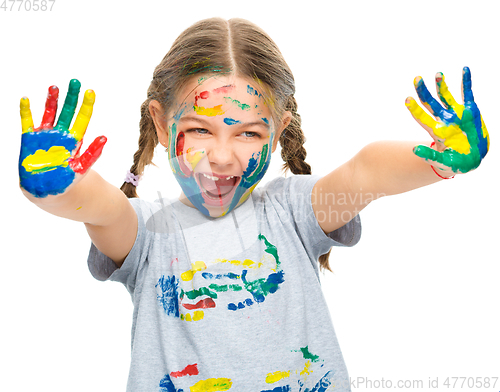 Image of Portrait of a cute girl playing with paints