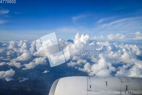 Image of Airplane flying above clouds