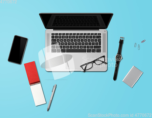 Image of Office desk mockup top view isolated on blue