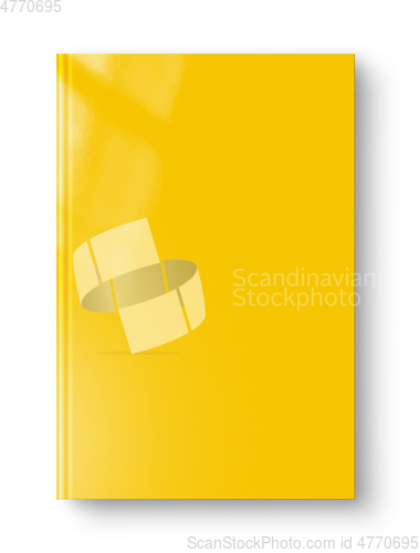 Image of Closed yellow blank book isolated on white