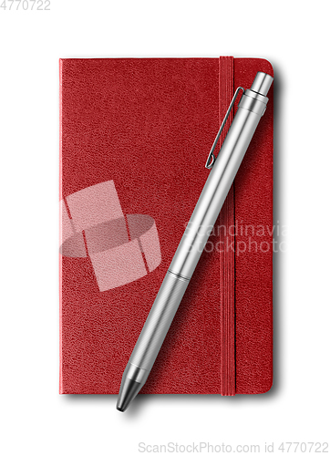 Image of Dark red closed notebook and pen isolated on white