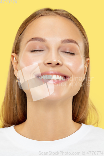 Image of Caucasian young woman\'s close up shot on yellow background