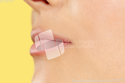 Image of Close up shot of young woman on yellow background