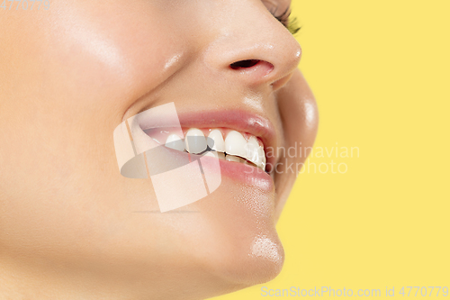 Image of Close up shot of young woman on yellow background
