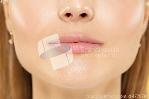 Image of Close up shot of young woman on yellow background