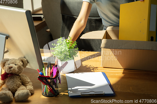 Image of A young businesswoman moving in office, getting new work place