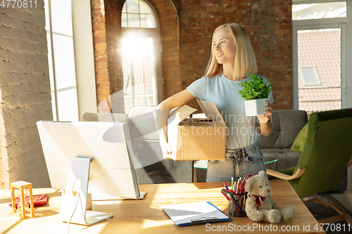 Image of A young businesswoman moving in office, getting new work place