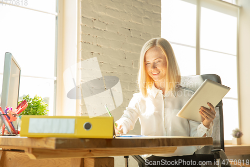 Image of A young businesswoman moving in office, getting new work place