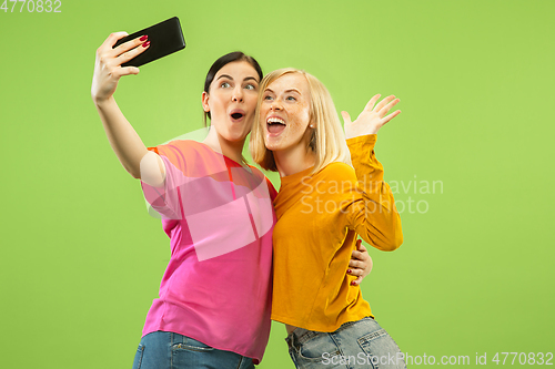 Image of Portrait of pretty girls isolated on green studio background