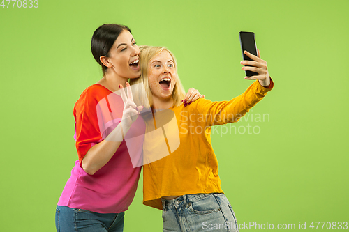 Image of Portrait of pretty girls isolated on green studio background