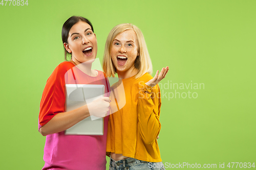 Image of Portrait of pretty girls isolated on green studio background