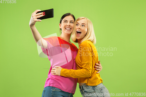 Image of Portrait of pretty girls isolated on green studio background