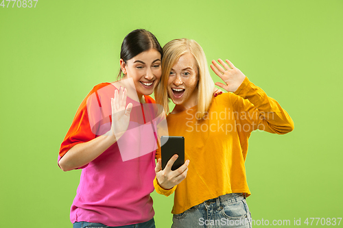 Image of Portrait of pretty girls isolated on green studio background