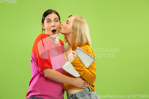 Image of Portrait of pretty girls isolated on green studio background