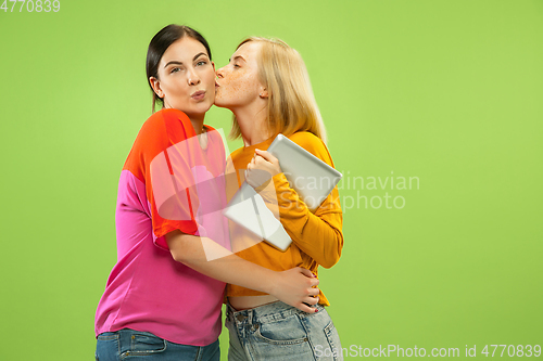Image of Portrait of pretty girls isolated on green studio background