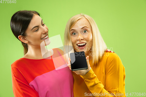 Image of Portrait of pretty girls isolated on green studio background