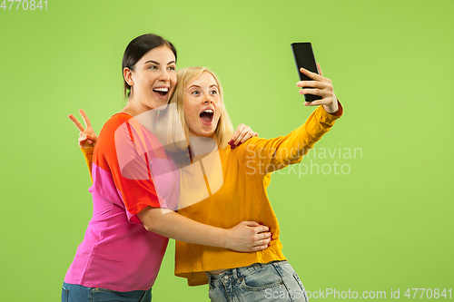 Image of Portrait of pretty girls isolated on green studio background