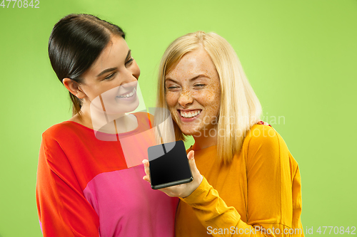 Image of Portrait of pretty girls isolated on green studio background