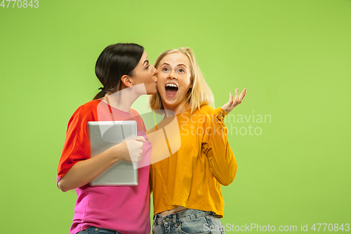 Image of Portrait of pretty girls isolated on green studio background