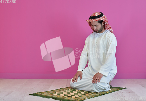 Image of Young muslim man praying salat during Ramadan