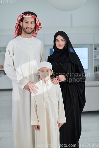 Image of Portrait of young arabian muslim family wearing traditional clothes