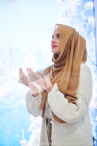 Image of Portrait of young muslim woman praying or making dua to God