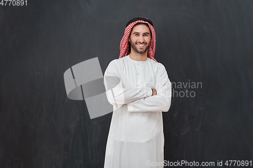 Image of Young muslim man with crossed arms smiling