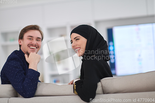 Image of Young muslim couple enjoing time together at home during Ramadan