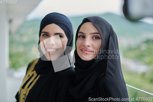 Image of Portrait of young muslim women on the balcony