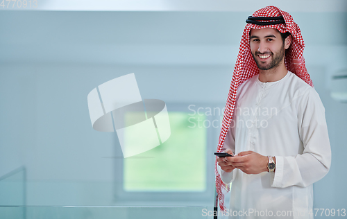 Image of Portrait of young muslim businessman using mobile phone