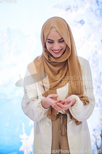 Image of Girl wearing hijab posing on winter concept background