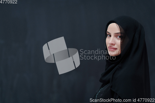Image of Modern young muslim woman in black abaya