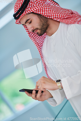 Image of Portrait of young muslim businessman using mobile phone