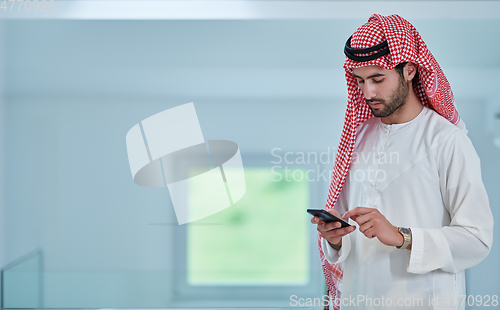 Image of Portrait of young muslim businessman using mobile phone