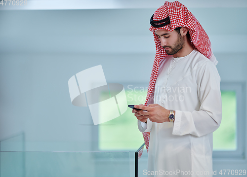 Image of Portrait of young muslim businessman using mobile phone