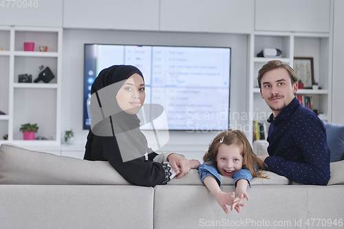 Image of Happy Muslim family spending time together in modern home