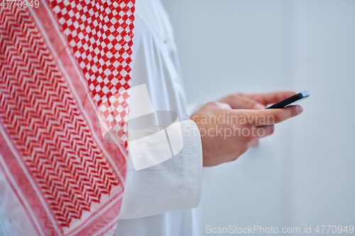Image of Portrait of young muslim businessman using mobile phone