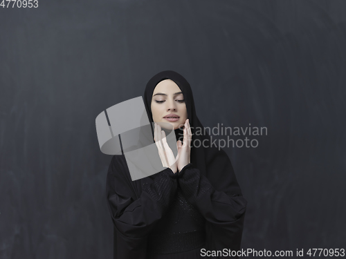 Image of Portrait of young Muslim woman making dua