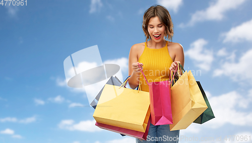 Image of happy smiling young woman with shopping bags