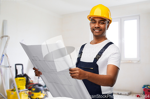 Image of happy indian builder in helmet with blueprint