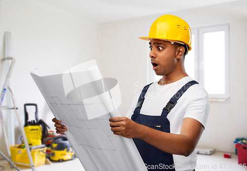 Image of shocked indian builder in helmet with blueprint