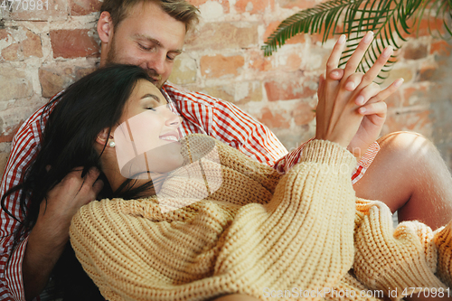 Image of Couple of lovers at home relaxing together, comfortable