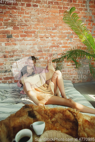 Image of Couple of lovers at home relaxing together, comfortable