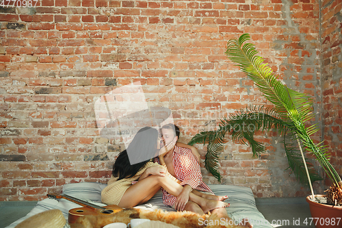 Image of Couple of lovers at home relaxing together, comfortable